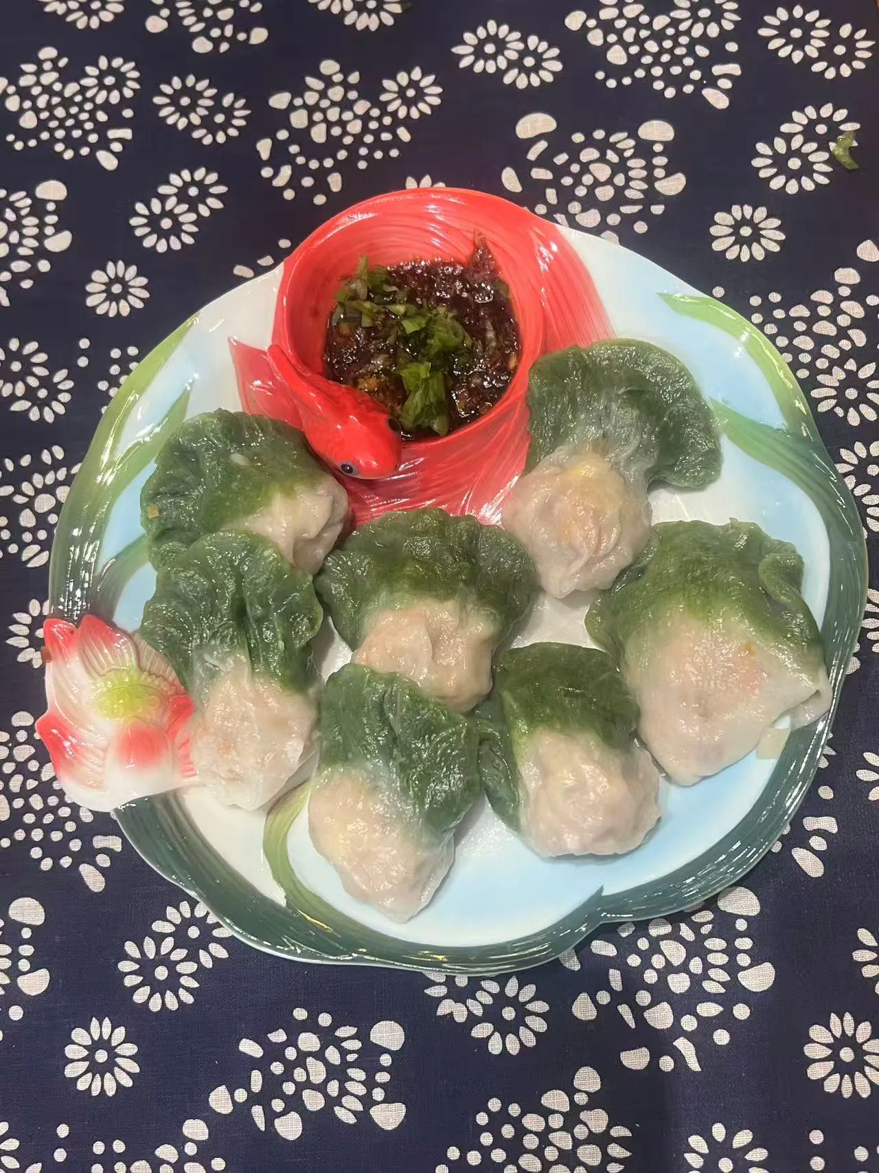 Steamed shrimp dumplings with translucent green-and-white wrappers, served with dipping sauce on decorative plate at Endless Art And Food, an Asian Fushion Restaurant in Catskill